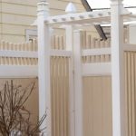 White PVC privacy fence with decorative residential backyard