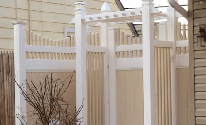 White PVC privacy fence with decorative residential backyard